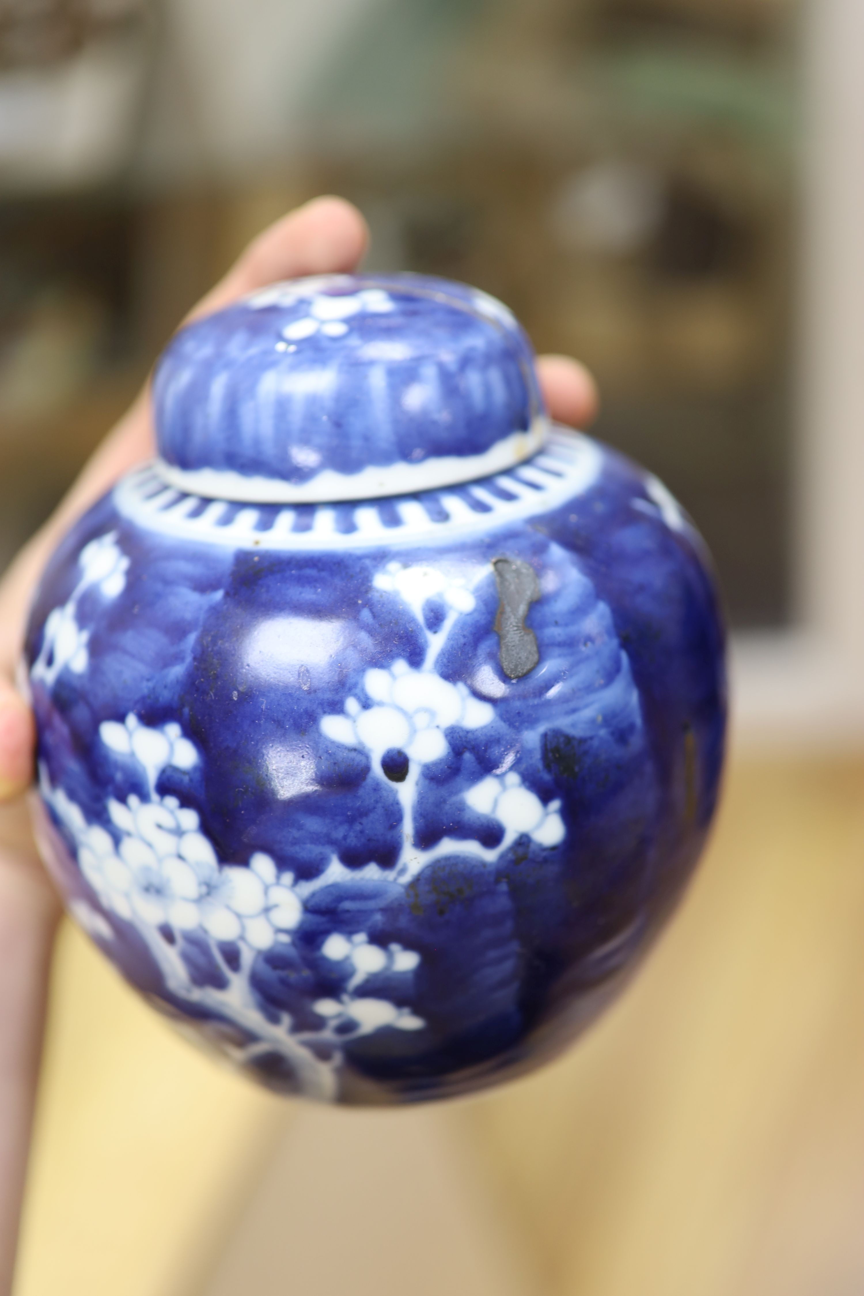 Two Chinese blue and white prunus pattern ginger jars and a similar cylinder vase, tallest 26cm